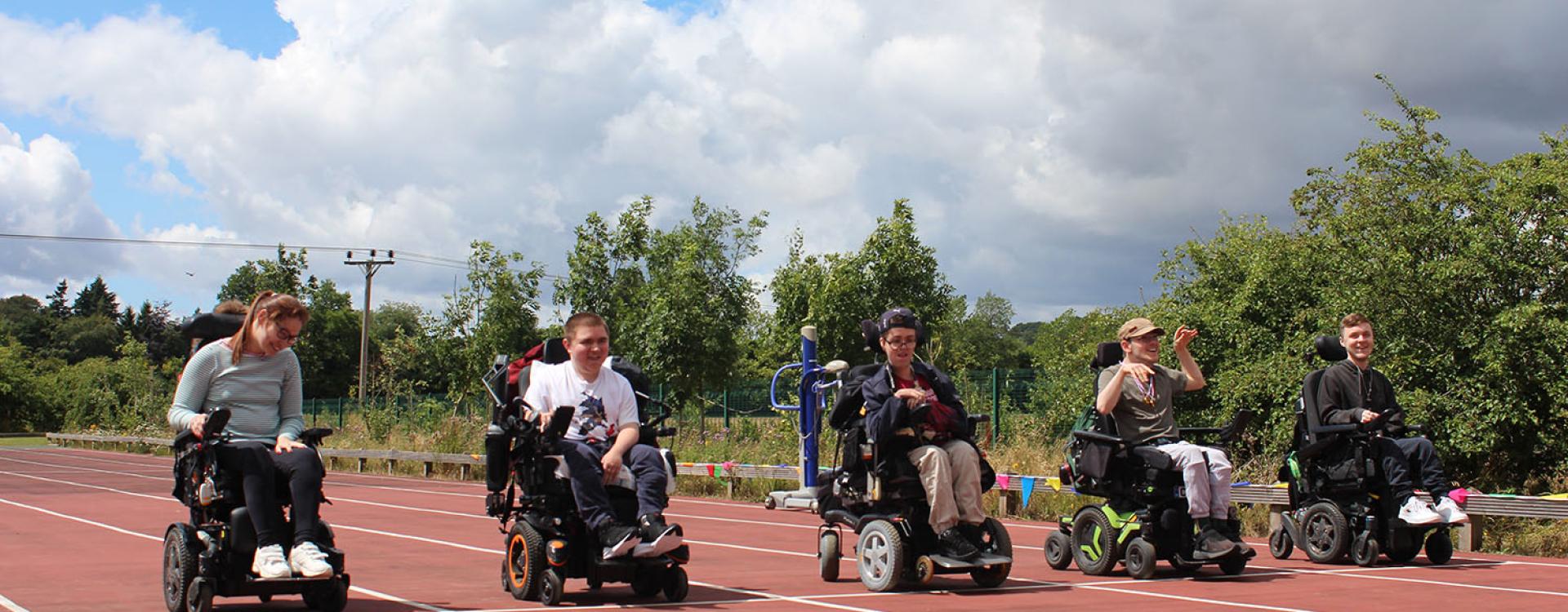 Treloar College students at the start line on a race track ready for the race to begin.