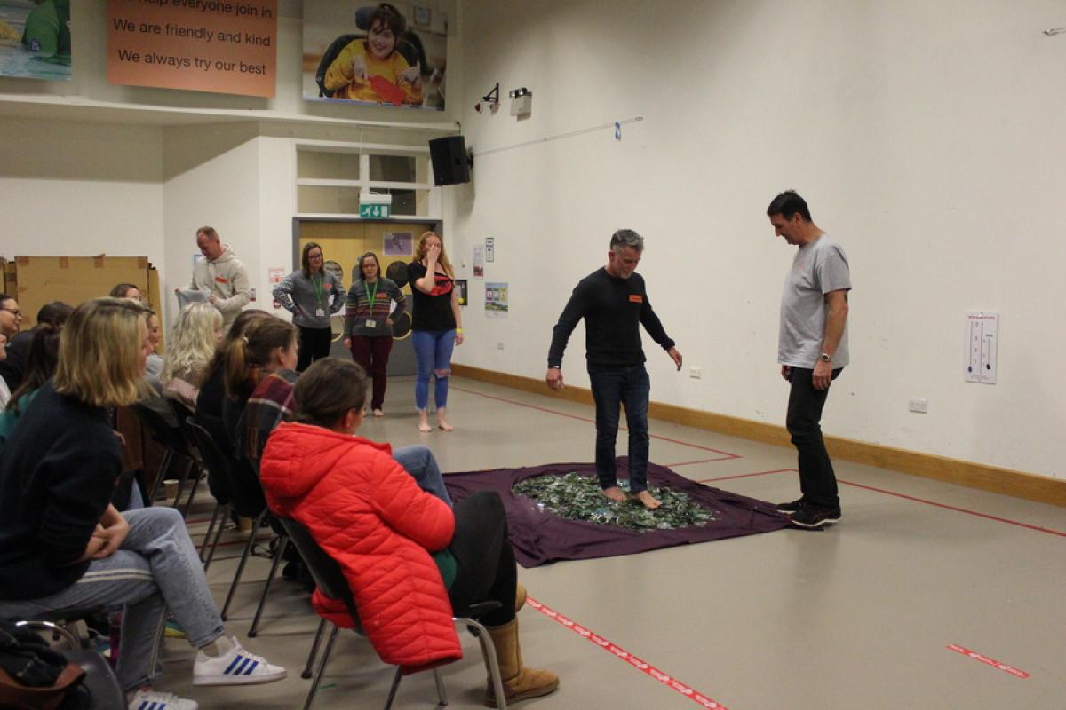 Firewalk participant walking on glass during the seminar 