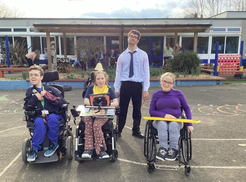 Four college students visiting a local primary school