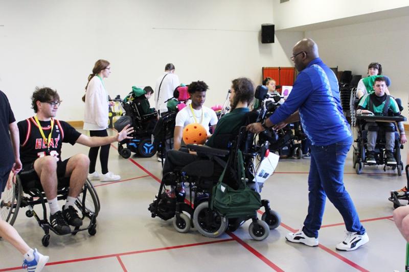 Students from HSDC Alton College playing inclusive sports with Treloar's students: here Alton College student is reaching for a ball from Treloar's student.