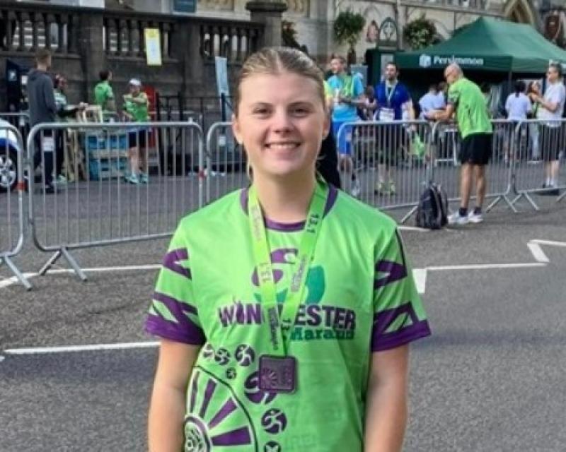 Lauren after finishing the Winchester Half-Marathon - wearing a green T-shirt.