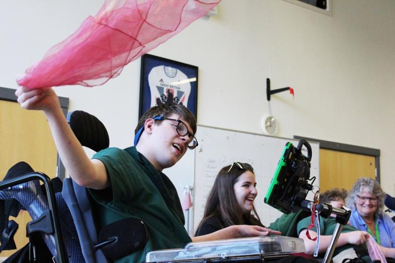 Treloar's student waving a pink shawl.