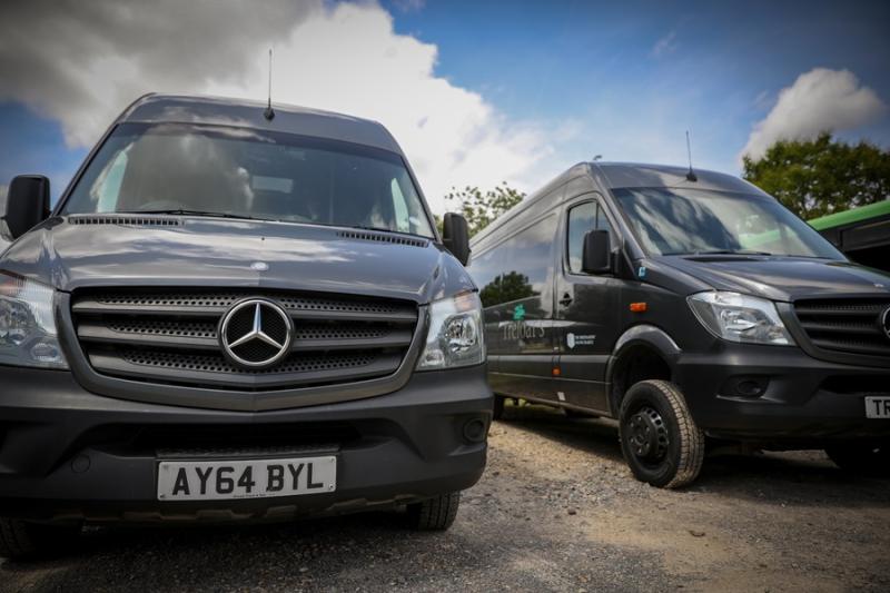 Treloar's specialist vehicles: two grey minibuses.