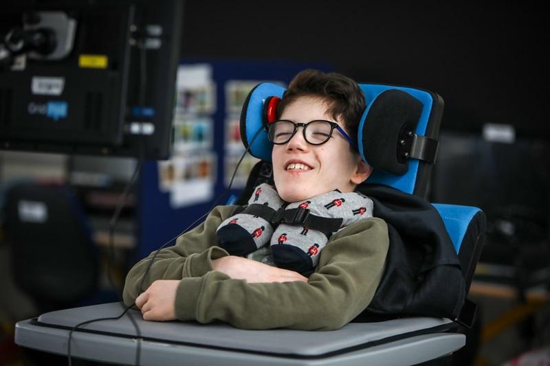 School student using a head switch to access technology