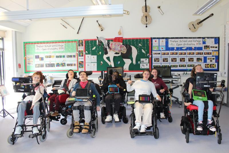 Treloar College orchestra - the group of students all lined up, posing for a group photo in the music classroom.