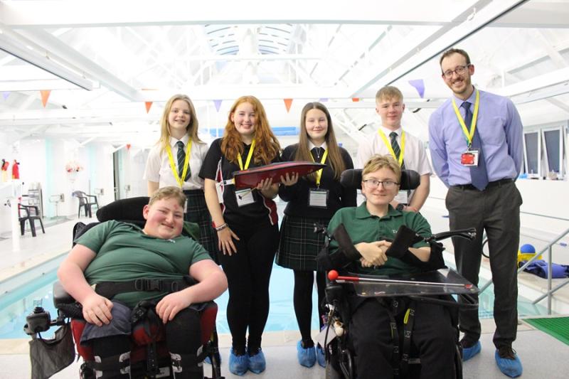 Will Redfearn, STEM teacher at Eggar's school, together with a group of Eggar's students and 2 Treloar School student in a group shot at Treloar's pool.reloar’s enjoyed a fun afternoon session exploring the idea of floatation in regard to boats. 