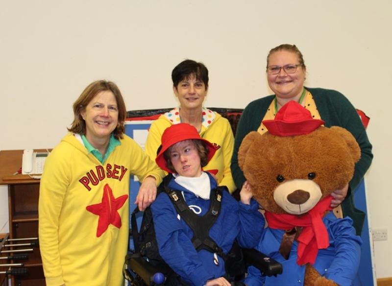 Treloar's PE Team with Treloar School student and a giant teddy bear.