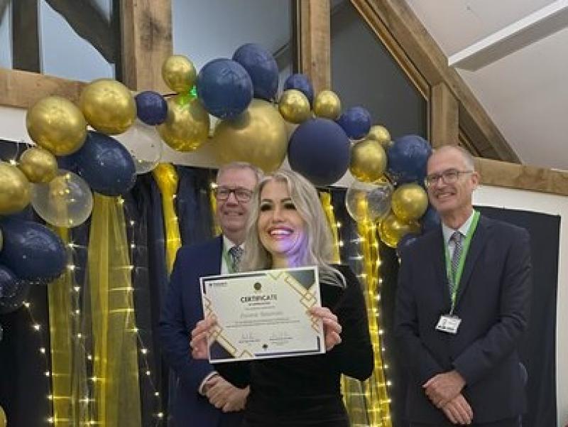 Donna, Deputy Lead Student Support Assistant at Treloar's, received a certificate; behind her Treloar's Principal and Independent Governor, Professor Rob Darracott