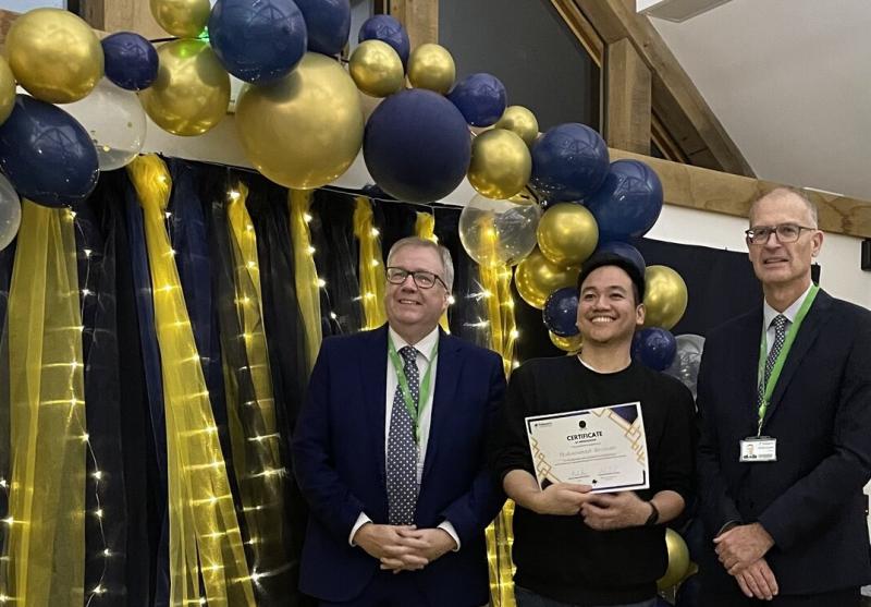 Zizan Rozman, Treloar's Team Leader at Evans House, holding his certificate at the Celebration of Success event