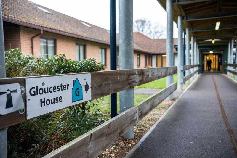 A long path to Gloucester House at Treloar's, with signage attached to wooden banister