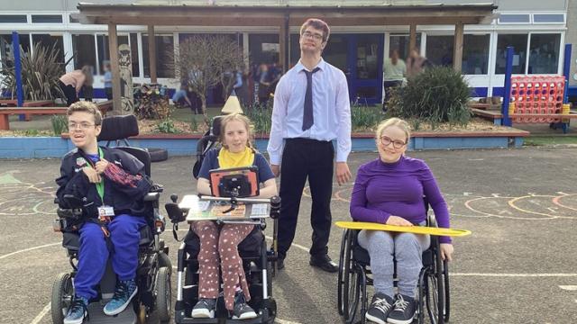 Four college students visiting a local primary school