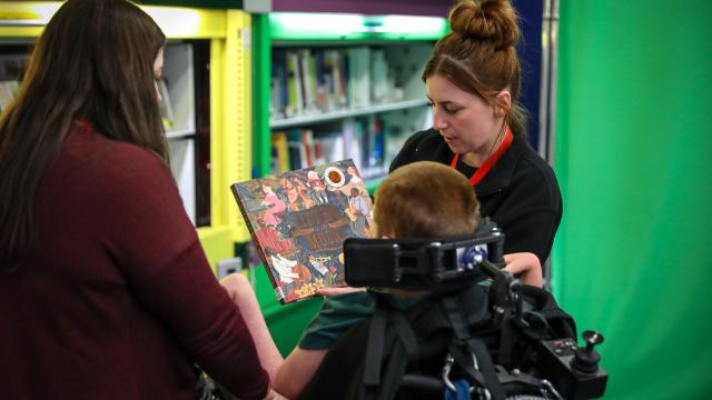 Child with member of staff and parent