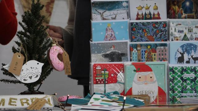 A stall with Christmas cards and decorations.