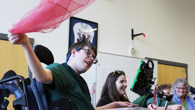 Treloar's student waving a pink shawl.