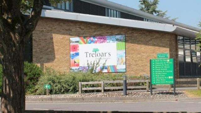 The front of Treloar's building seen from the driveway; a big logo of Treloar's attached to the wall.