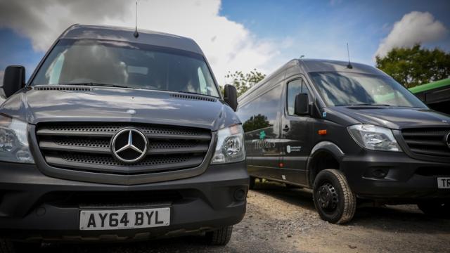 Treloar's specialist vehicles: two grey minibuses.