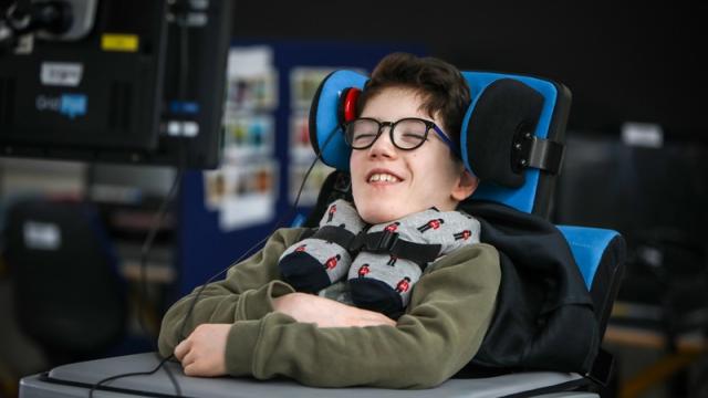 School student using a head switch to access technology