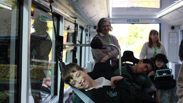 Treloar's students on a new electric bus with staff - all excited to be on it for the first time.