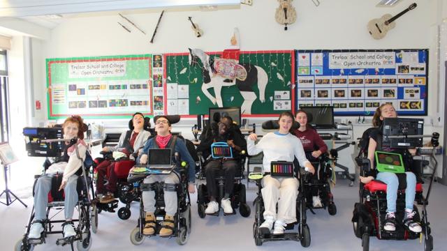 Treloar College orchestra - the group of students all lined up, posing for a group photo in the music classroom.