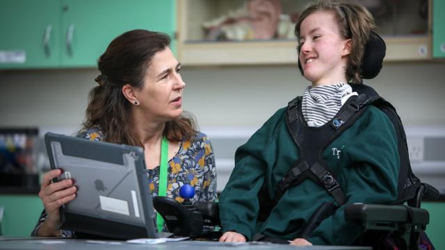 Treloar's student working with a support assistant in the science classroom