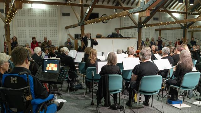 A wide shot of Alton Concert Orchestra playing in The Alton Maltings Centre, with Alessandro playing the Clarion