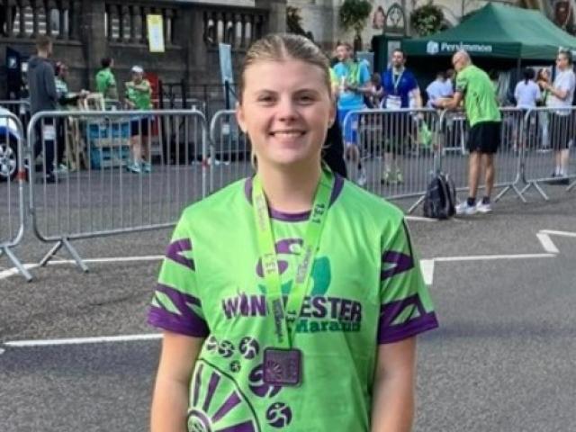 Lauren after finishing the Winchester Half-Marathon - wearing a green T-shirt.