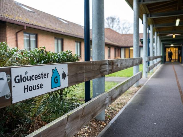 A long path to Gloucester House at Treloar's, with signage attached to wooden banister