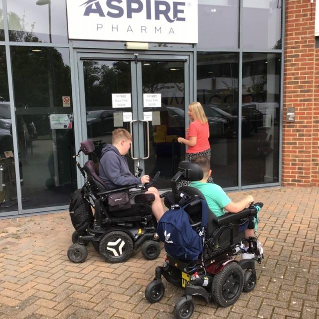 2 Treloar College students in front of the building of a pharmaceutical company Aspire; they are about to enter the building.