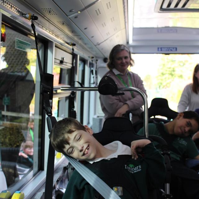 Treloar's students on a new electric bus with staff - all excited to be on it for the first time.