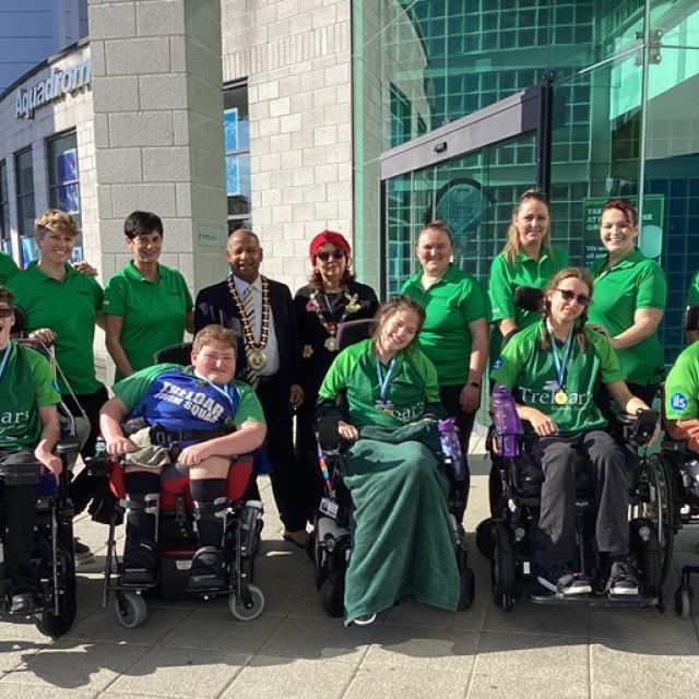 Treloar's Swim Squad posing for a group photo outside with the Mayor of Basingstoke and Deane.