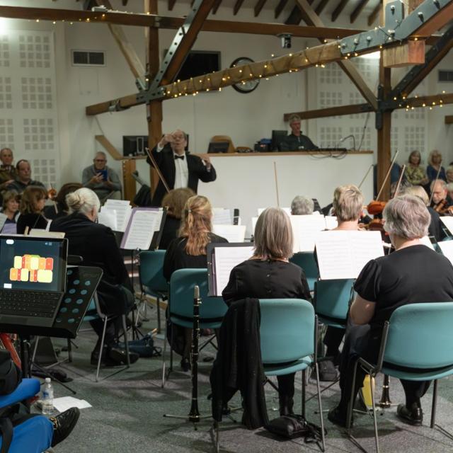 A wide shot of Alton Concert Orchestra playing in The Alton Maltings Centre, with Alessandro playing the Clarion