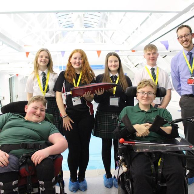 Will Redfearn, STEM teacher at Eggar's school, together with a group of Eggar's students and 2 Treloar School student in a group shot at Treloar's pool.reloar’s enjoyed a fun afternoon session exploring the idea of floatation in regard to boats. 