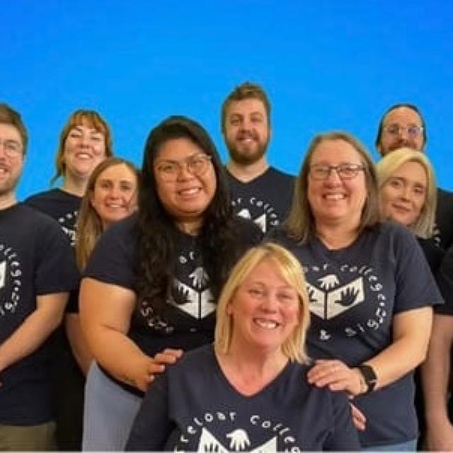 A group photo of Treloar College Sing and Sign Team, consisting of Makaton tutors and Treloar's staff. All wearing matching T-shirts.