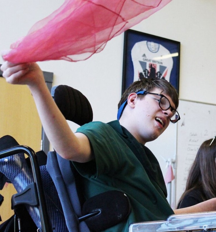 Treloar's student waving a pink shawl